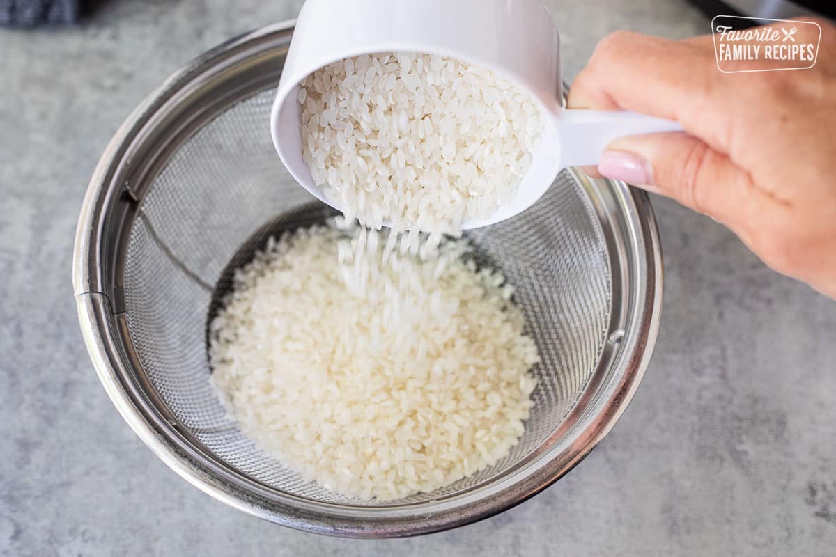 Pouring rice into colander.