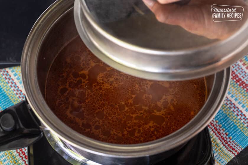 Simmering rice in a pot for making a Mexican rice recipe.