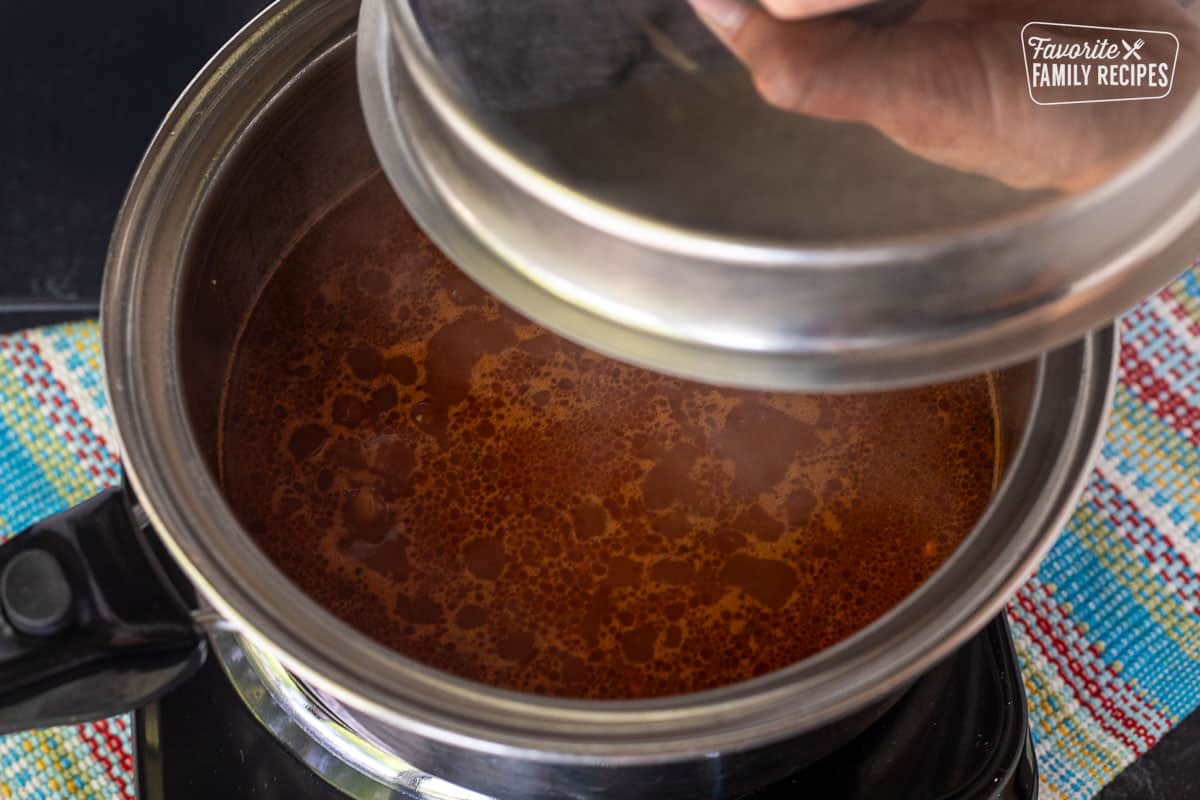 Simmering rice in a pot for making a Mexican rice recipe.