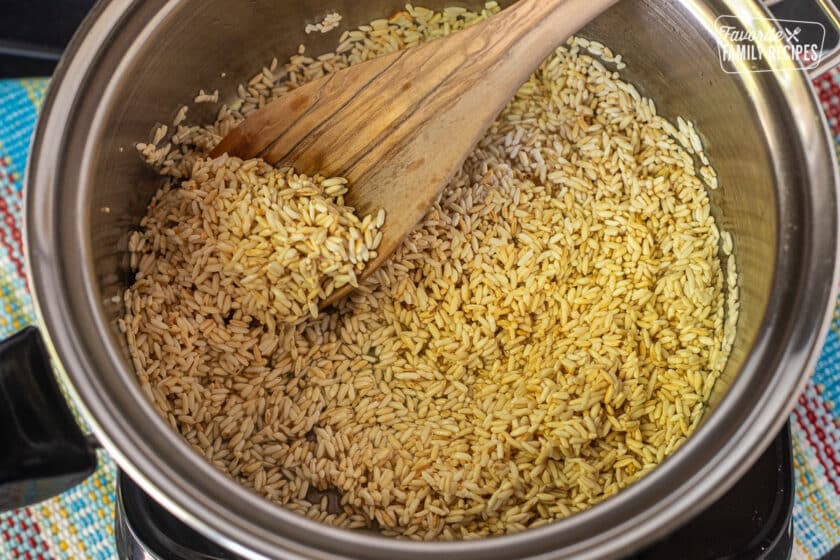 Golden cooked rice in a saucepan, a step to making restaurant-style Mexican rice.