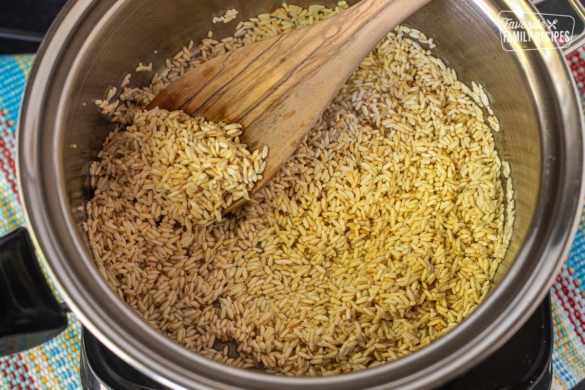 Golden cooked rice in a saucepan, a step to making restaurant-style Mexican rice.