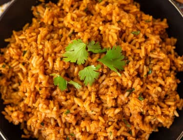 Easy Mexican Rice recipe, bowl of cooked rice with cilantro.