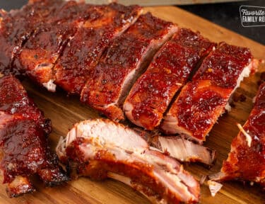 Cut up Smoked Ribs on a cutting board.