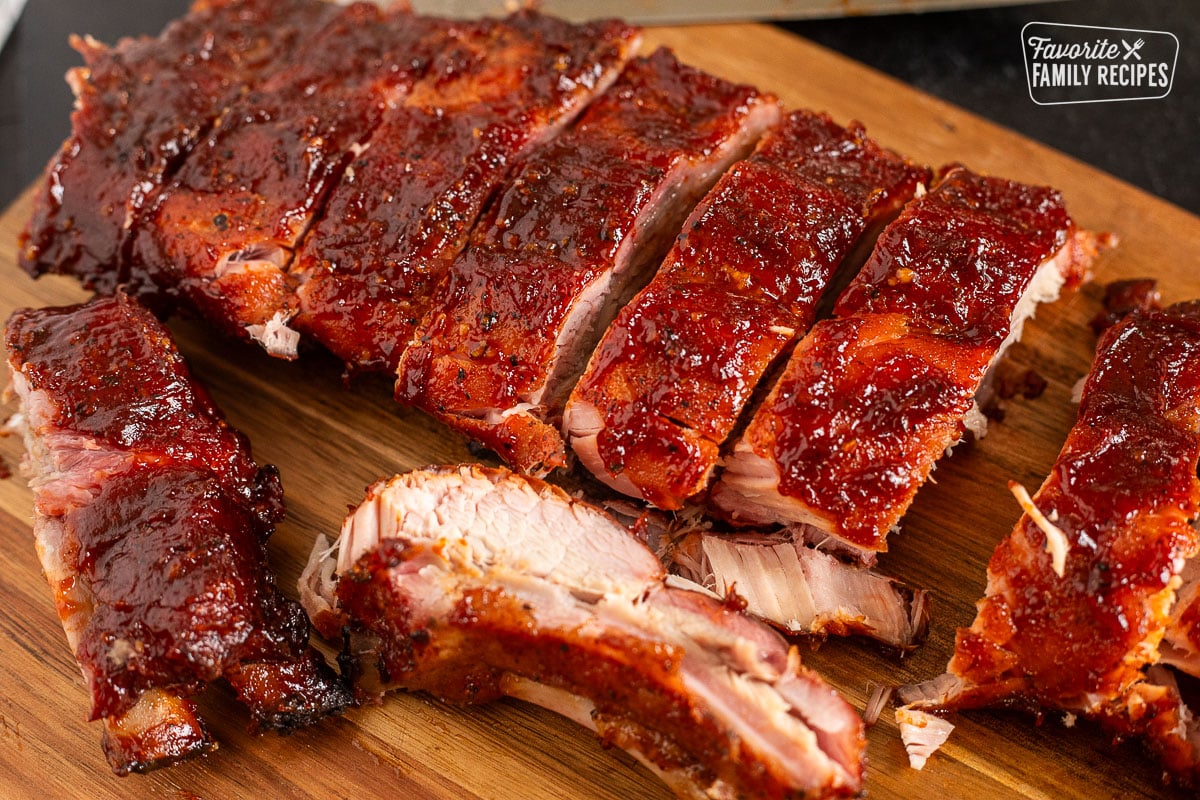 Cut up Smoked Ribs on a cutting board.