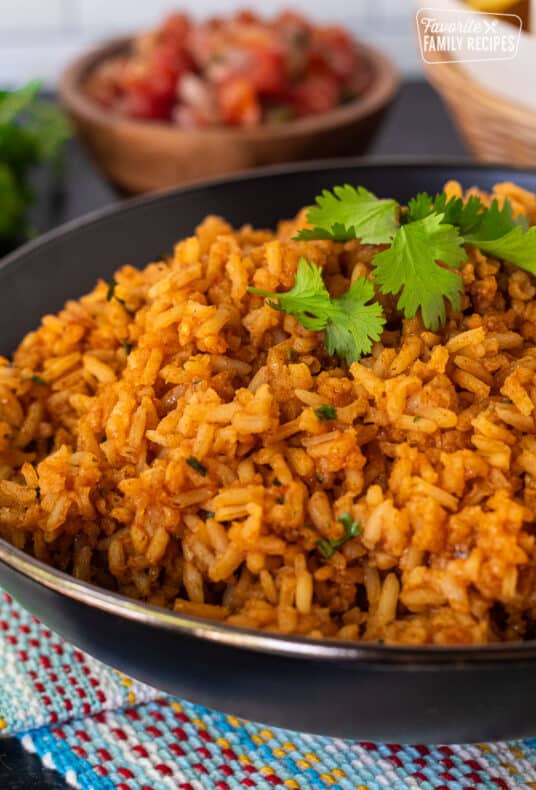 Bowl of Mexican Rice with Cilantro garnished on top.