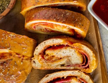 Slices of Stromboli with pizza sauce.