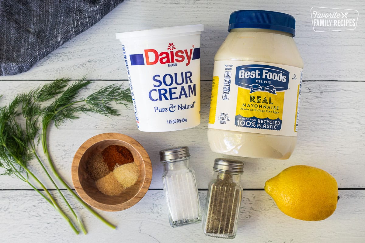 Ingredients to make Veggie Dip including mayonnaise, sour cream, seasonings, lemon, dill, salt and pepper.