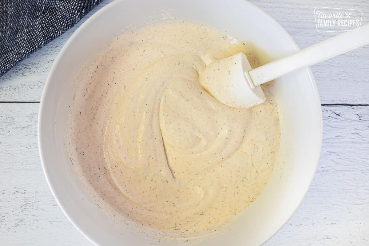 Mixed Veggie dip in bowl with a small spatula.