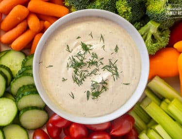 Bowl of Veggie Dip surrounded by fresh vegetables.