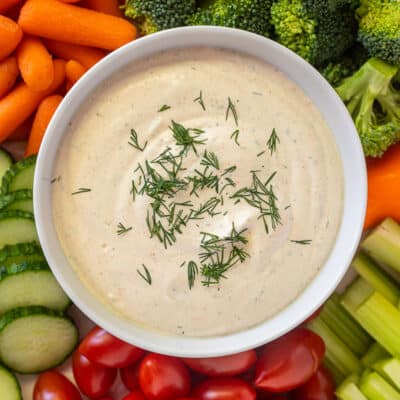 Bowl of Veggie Dip surrounded by fresh vegetables.