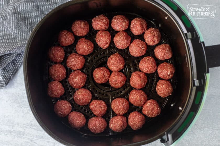 Air Fryer with raw meatballs.