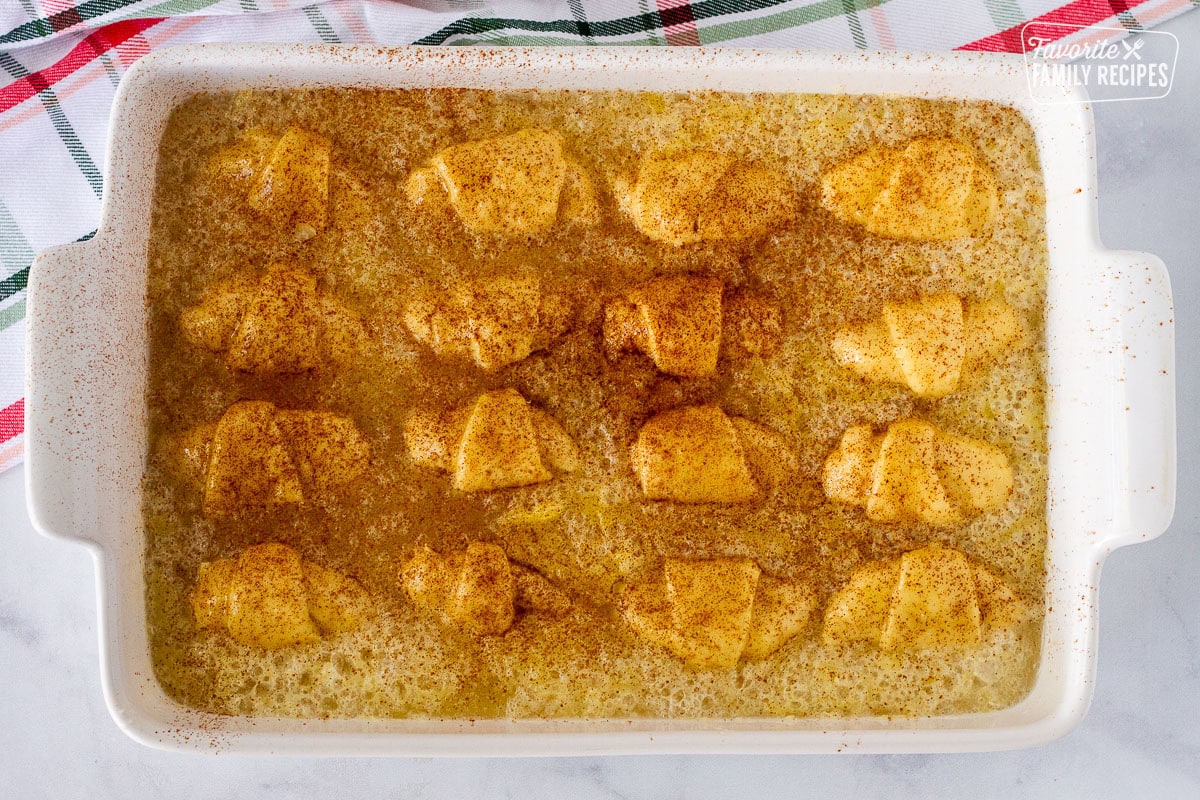 Unbaked Apple Dumplings topped with cinnamon.