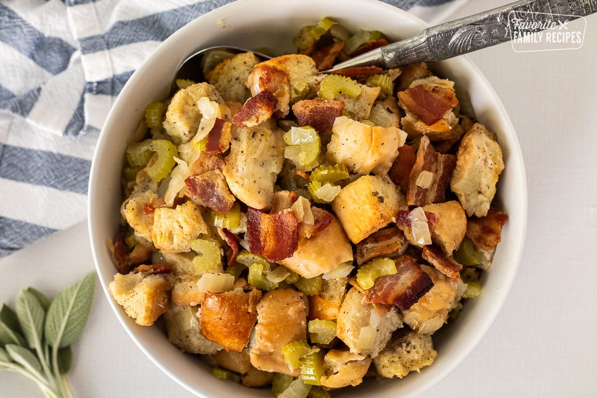 Large bowl with Bacon Stuffing and serving spoon.