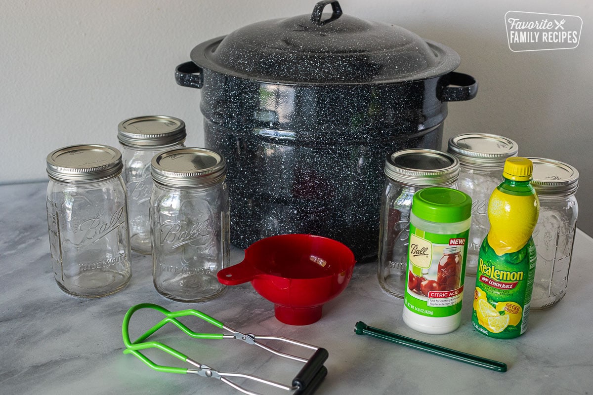 Canning pot, citric acid, lemon juice, canning jars, canning funnel, lid lifter and jar lifter tongs.