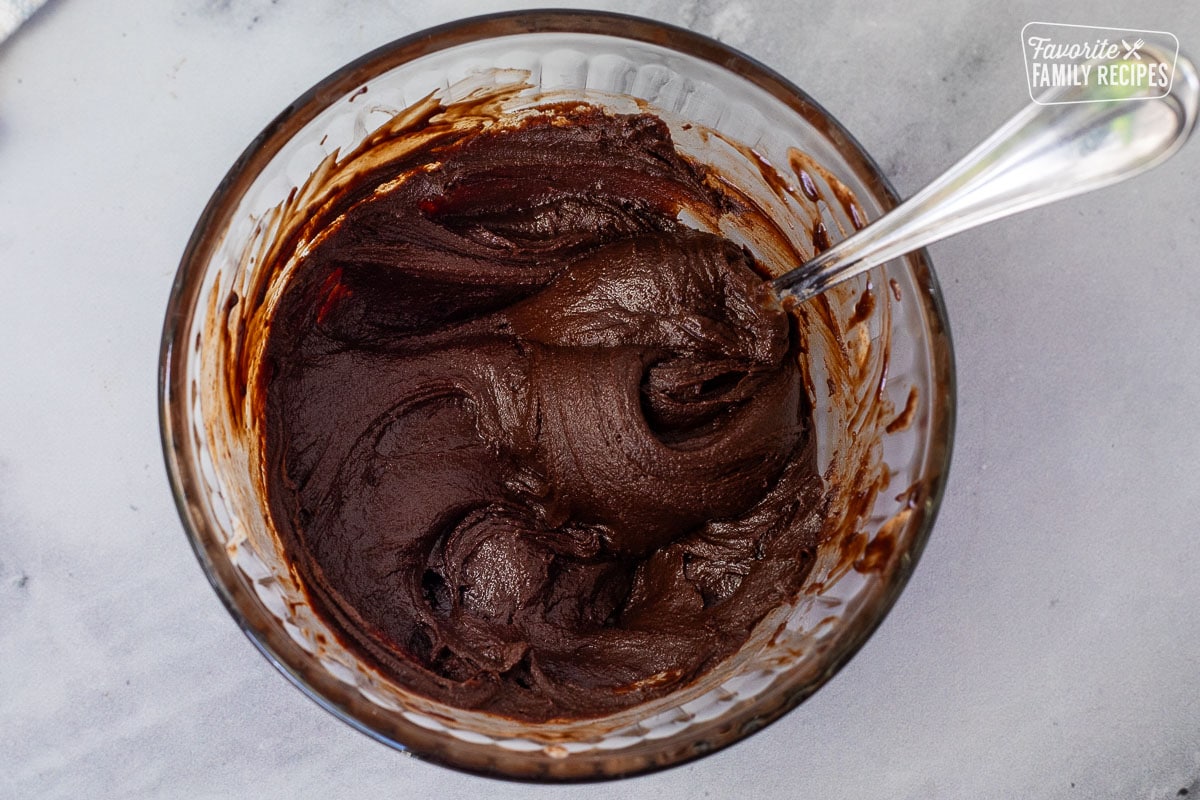 Small bowl of melted chocolate for Chocolate Satin Pie.