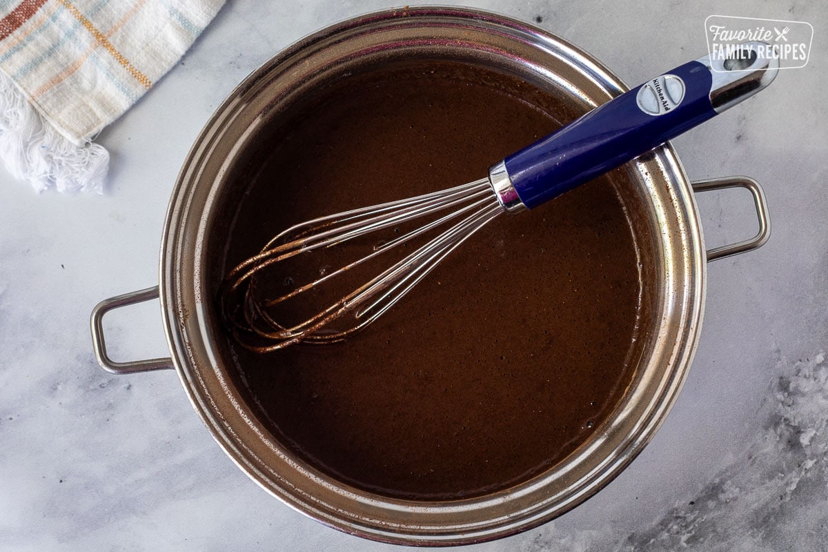 Whisked together chocolate ingredients in a pan for Chocolate Satin Pie filling.