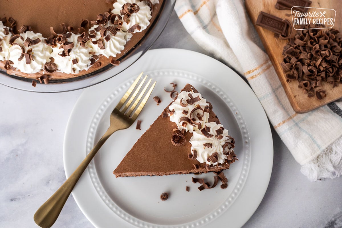 Top view of a slice of Chocolate Satin Pie on a plate with a fork.