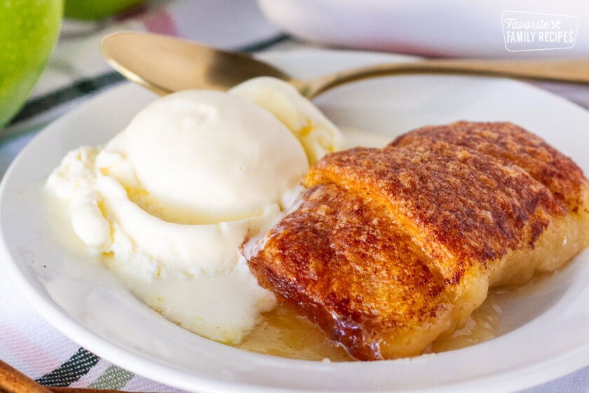 Apple Dumpling on a plate with a scoop of vanilla ice cream.