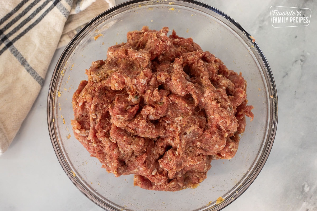 Glass bowl with meatball mixture.