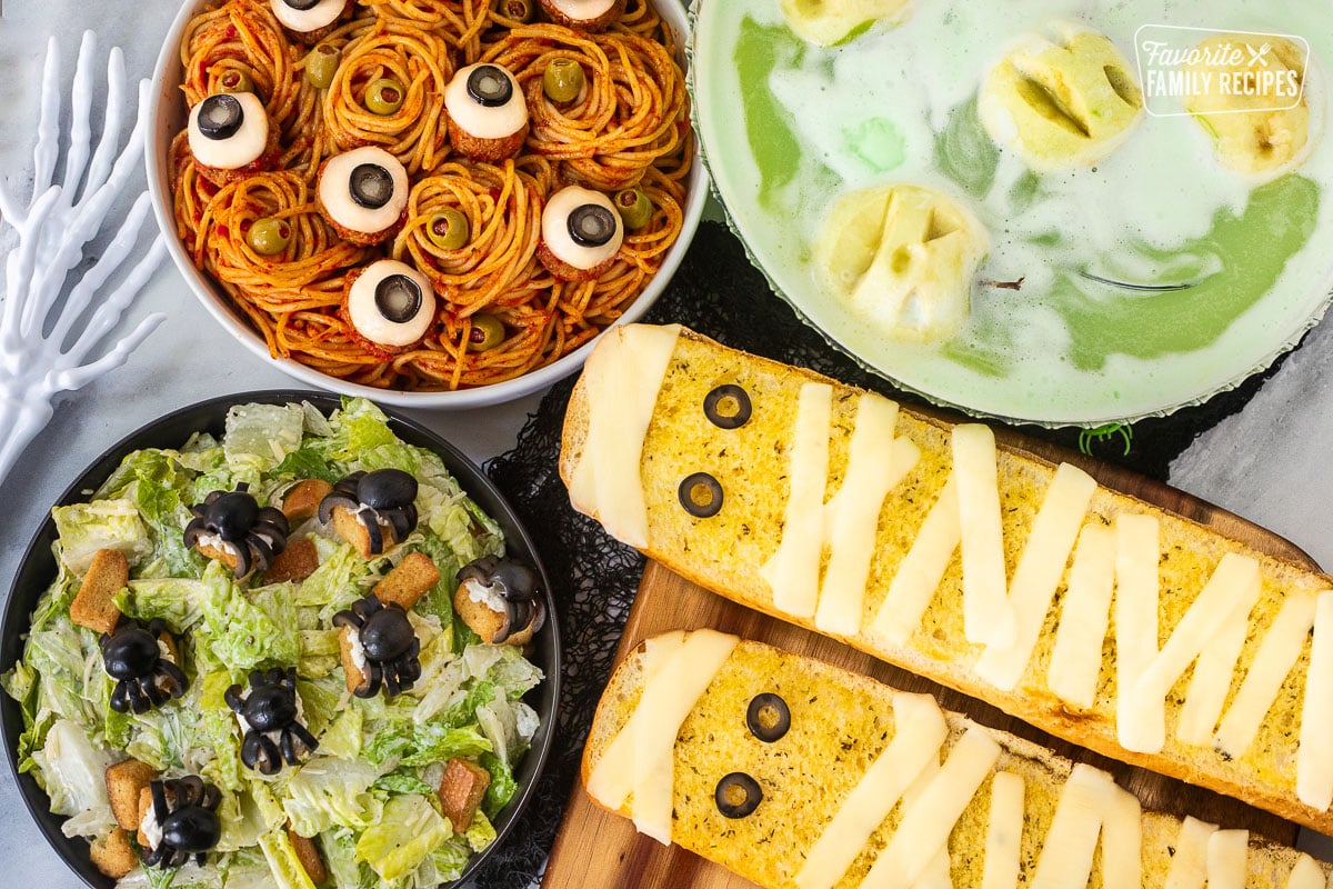 Halloween Dinner with spaghetti and eyeballs, spider Cesar salad, mummy garlic bread and shrunken head green punch.