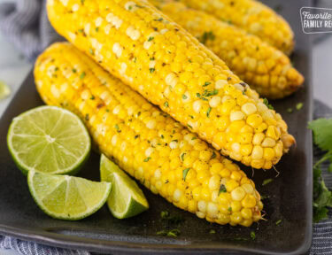 Grilled corn on the cob with lime and cilantro.