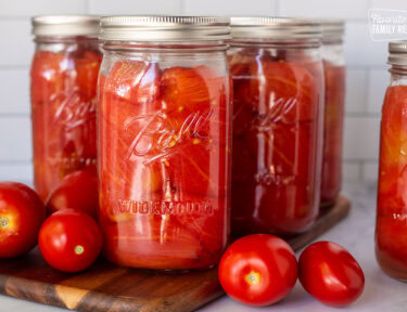 Canning jars of whole tomatoes.