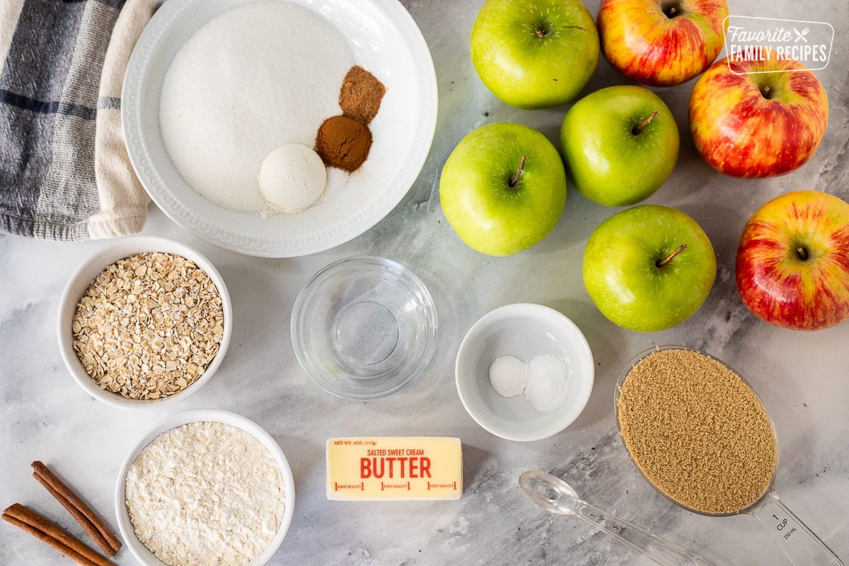 Apple Crisp ingredients including apples, sugar, cinnamon, nutmeg, flour, water, baking soda, baking powder, almond extract, brown sugar, oats and butter.