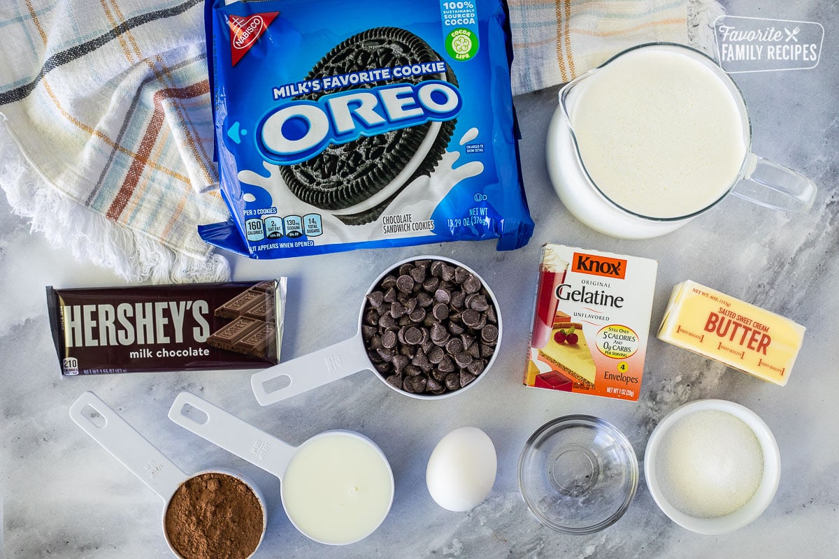 Ingredients to make Chocolate Satin Pie including Oreo cookies, heavy cream, milk, butter, Gelatin, sugar, water, egg, cocoa powder, chocolate chips and chocolate bar.