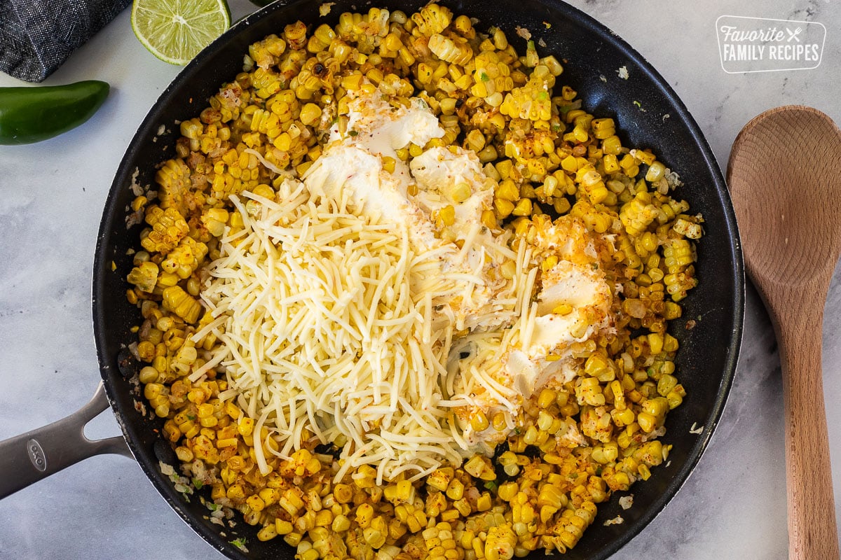 Skillet with corn and cheeses.