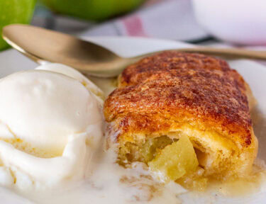 Apple Dumpling on a plate with ice cream.