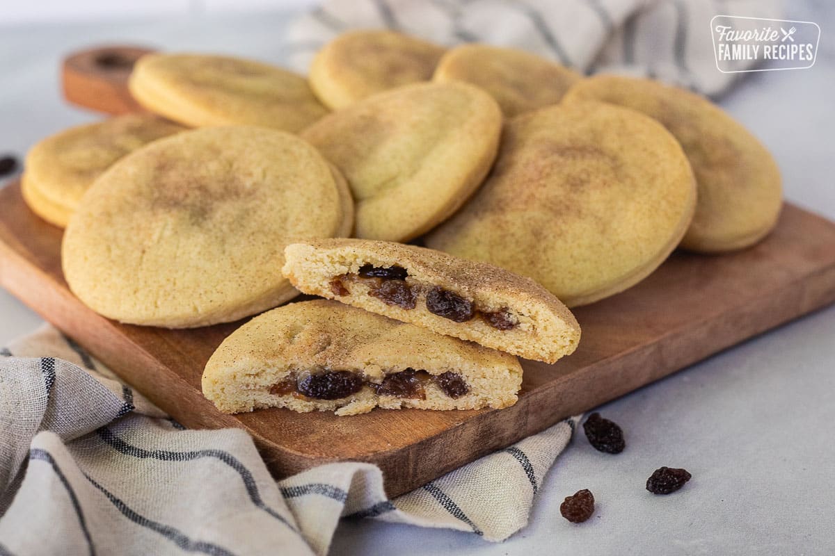 Cutting board with Raisin Filled Cookies and one cut in half.