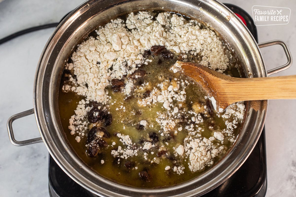 Stirring butter and flour into raisin mixture.