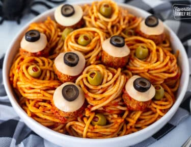 Spaghetti with olives and meatballs shaped like eyeballs.