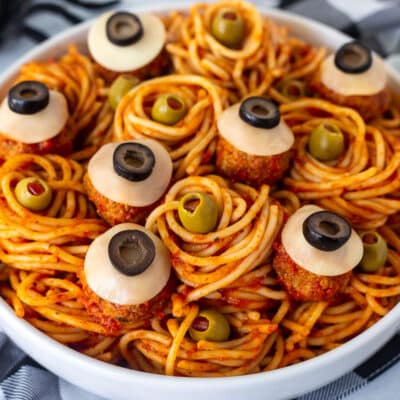 Spaghetti with olives and meatballs shaped like eyeballs.