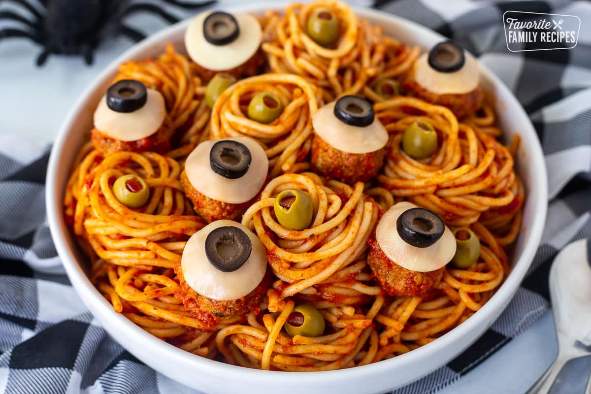 Spaghetti with olives and meatballs shaped like eyeballs.