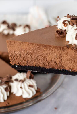 Holding a slice of Chocolate Satin Pie with pie spatula.