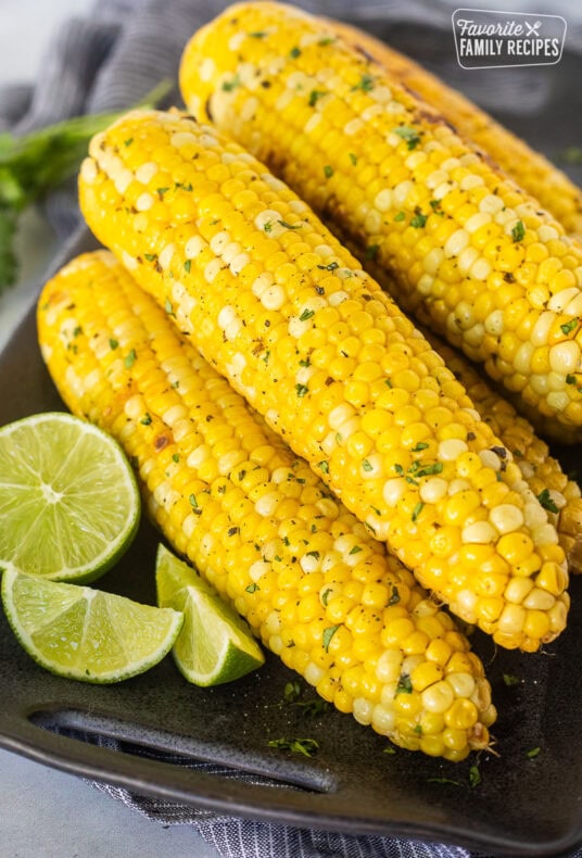 Grilled Corn on the Cob stacked on a platter.