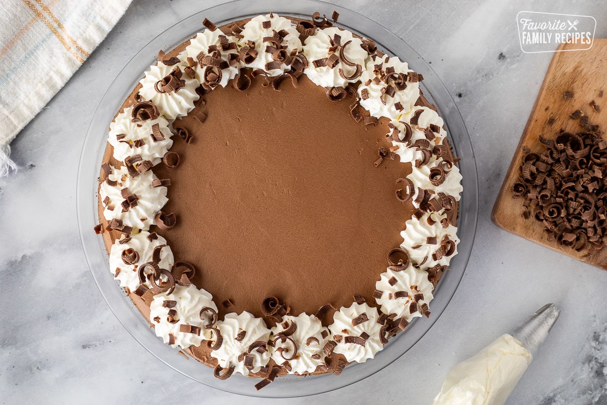 Decorated Chocolate Satin Pie with whipped cream and chocolate curls around the border.