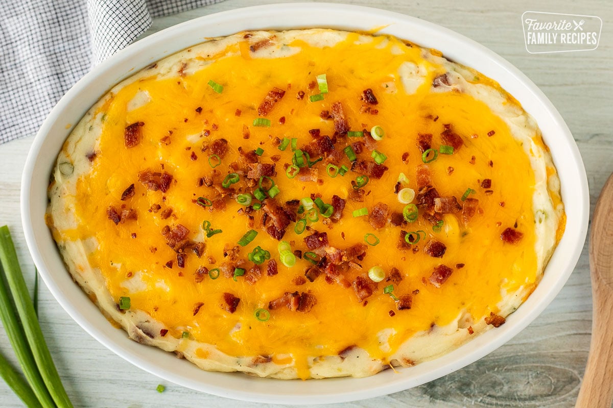 Baking dish of Loaded Mashed Potatoes with bacon and sliced green onions.