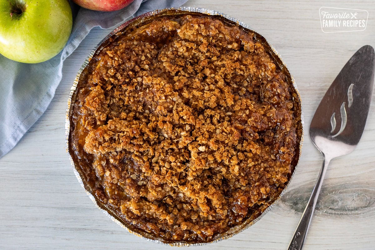 Whole baked Gluten Free Apple Pie. Spatula on the side.