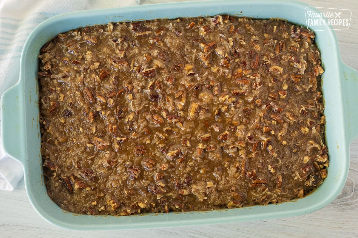 Baked Oatmeal Cake covered with pecan caramel topping in a baking dish.