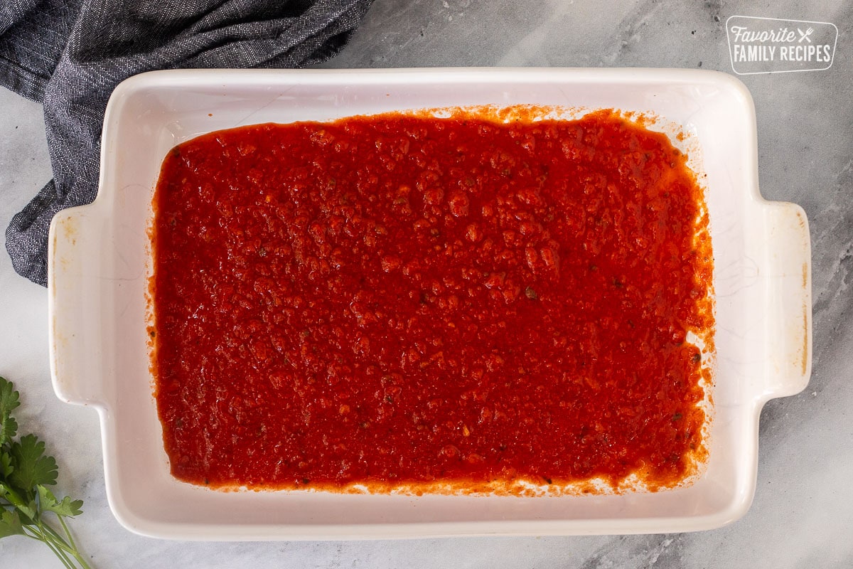 Baking dish with marinara sauce.