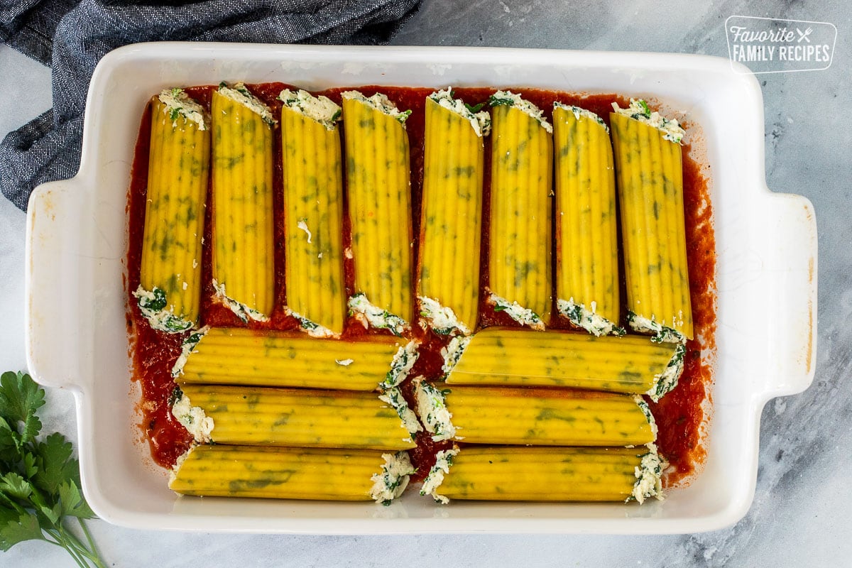 Baking dish with filled manicotti shells.