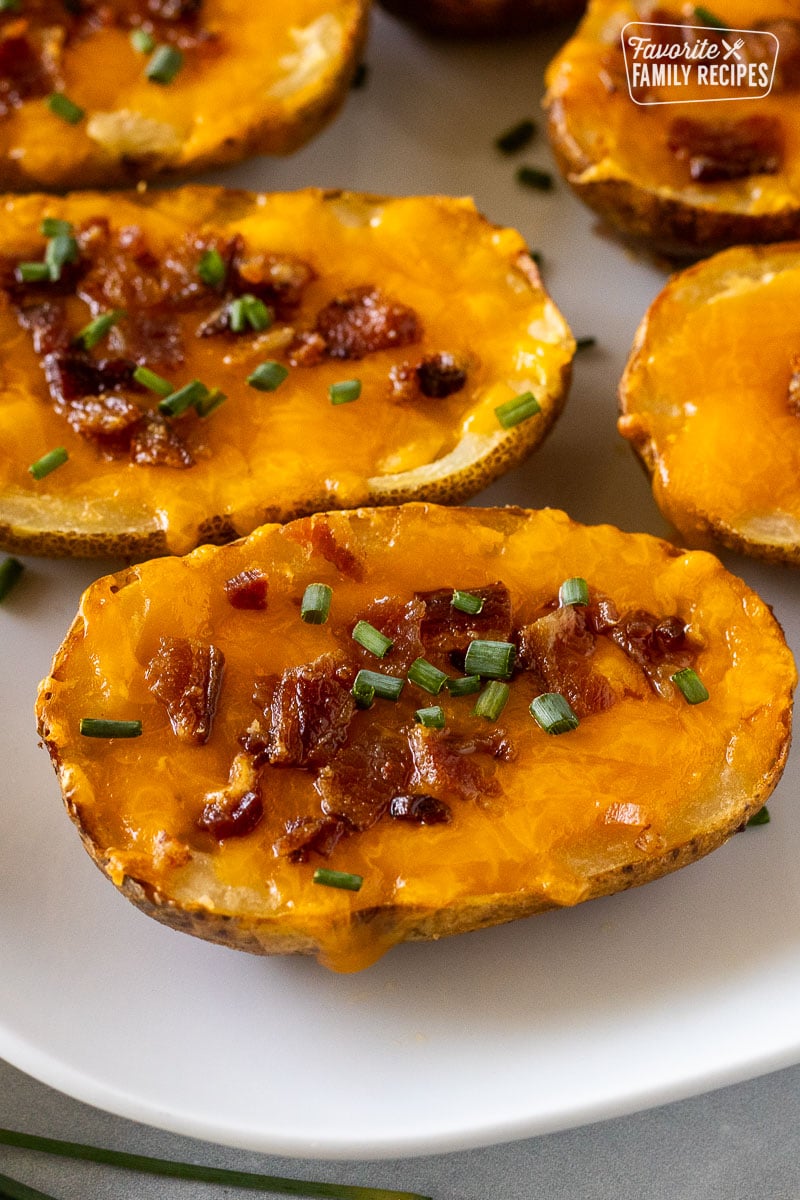 Loaded potato skin with cheddar cheese, bacon, and chives.