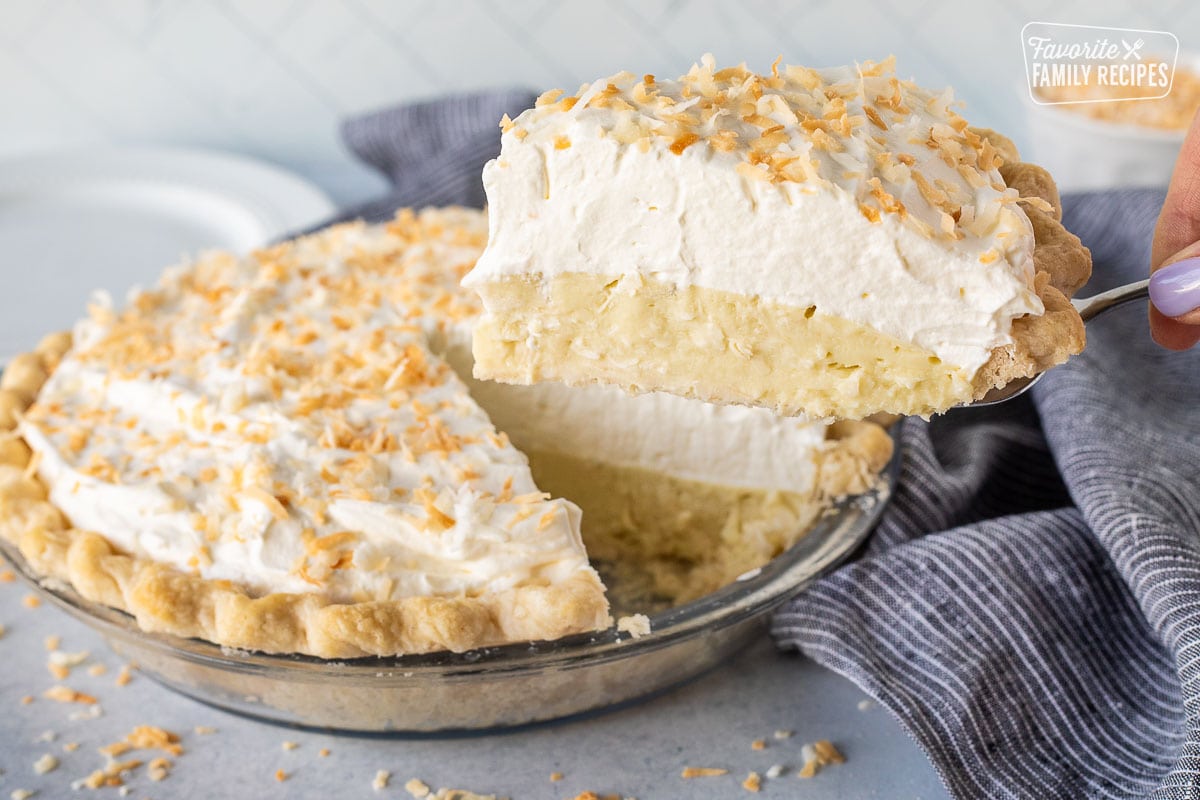 Spatula holding up a slice of Coconut Cream Pie.