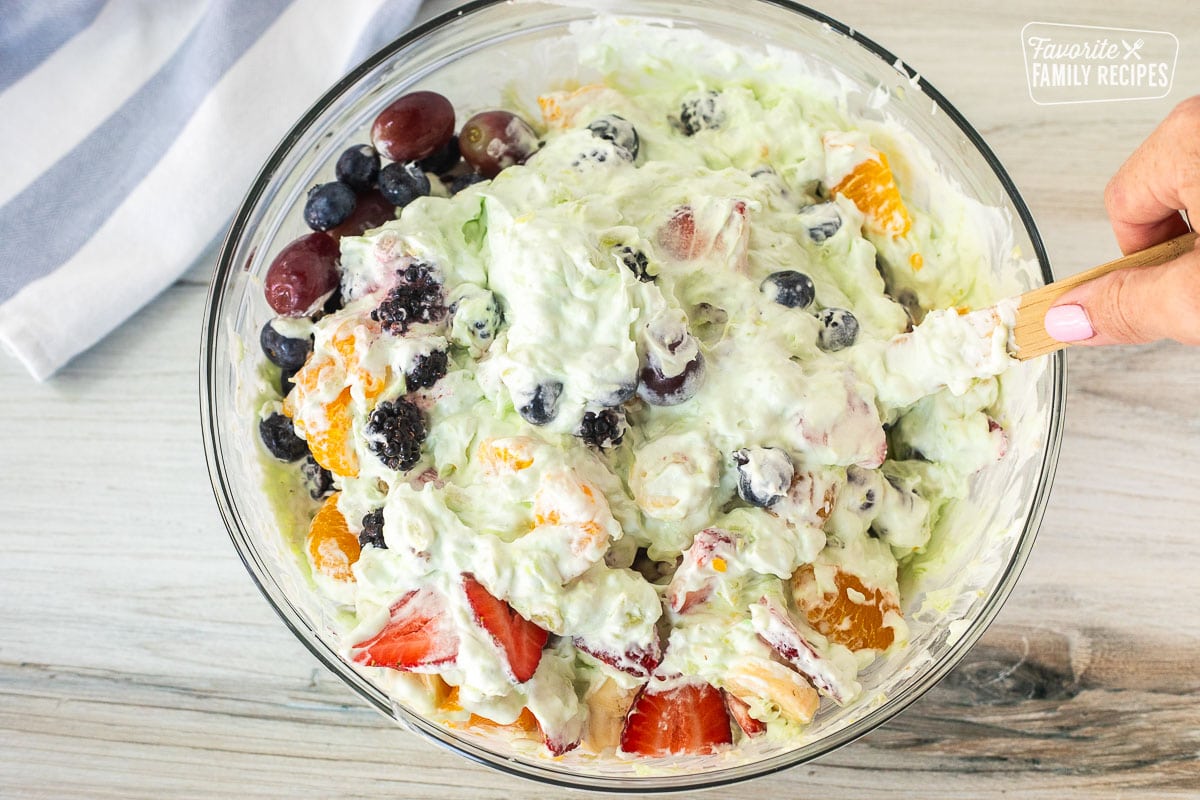 Mixing bowl with fruit combining with whipped mixture.