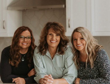 Emily, Echo, and Erica owners and authors of Favorite Family Recipes in a kitchen together