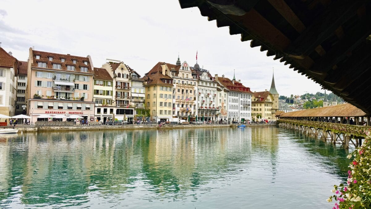 A picture of the city of Lucerne from the wooden bridge on the river