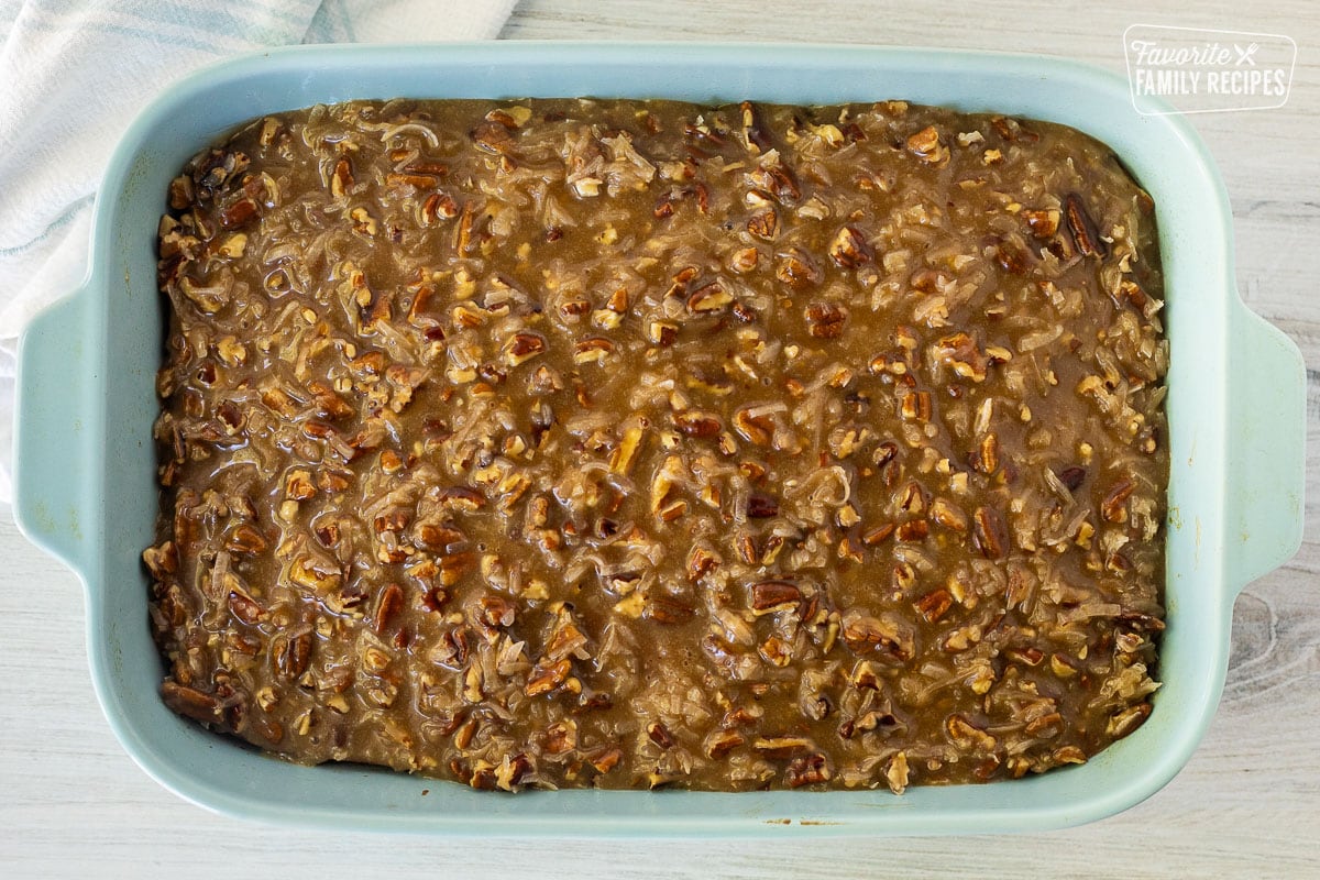 Oatmeal Cake covered with pecan caramel topping in a baking dish.