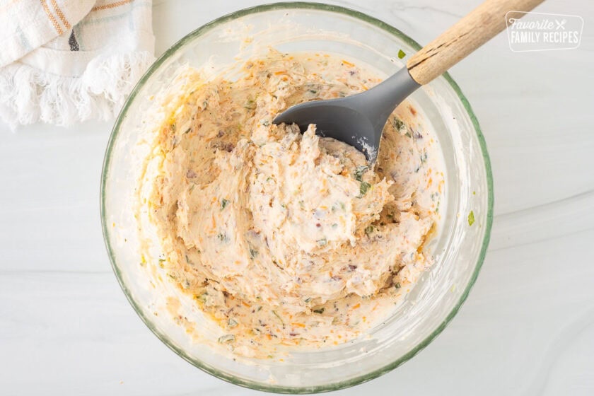 Pumpkin Shaped Cheese Ball mixture in a glass bowl.